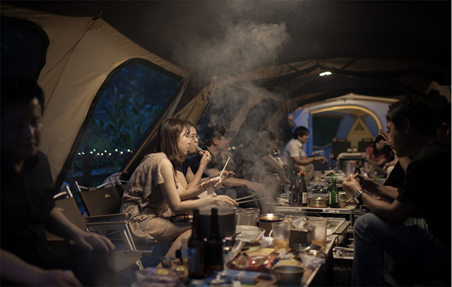어두워진 시간 더 블로거들이 텐트에 앉아 이야기를 나누며 음식을 먹고있다