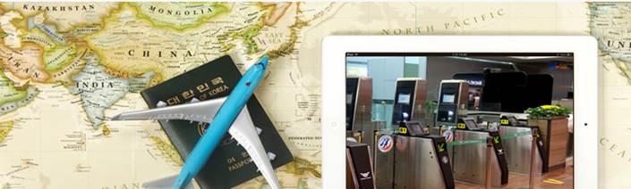 지도 위에 여권과 비행기 모형이 놓여져 있는 모습. 옆의 태블릿에는 자동출입국심사 게이트가 보인다. 
