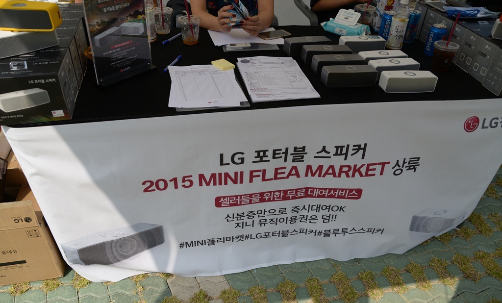 'LG 포터블 스피커 2015 미니 플리마켓 상륙' 문구가 적힌 현수막이 눈에 띈다.