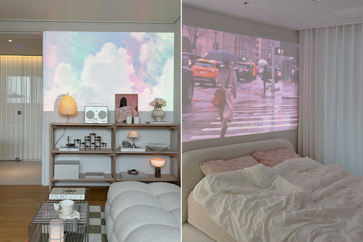 왼쪽 장면에서는 선반 위 조명과 소품들 사이에서 시네빔이 벽에 파스텔톤 구름 영상이 크게 투사된 밝은 거실 공간을 보여준다. 오른쪽 장면에서는 시네빔이 침실 벽에 우산을 쓰고 횡단보도를 건너는 사람들의 장면을 투사하고 있으며 화면 아래에는 작은 글씨로 music playlist라는 텍스트가 보인다. 커튼과 침대, 쿠션 등 부드러운 색감의 인테리어가 어우러져 차분한 분위기를 만든다.